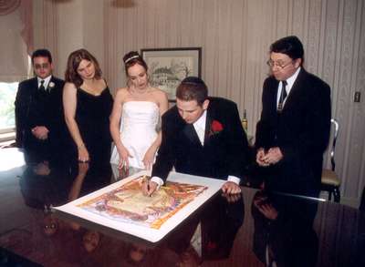 Adam, Katy, Steph, and Dan with Rabbi Brenner signing the ketubah (the Jewish marriage contract) before the ceremony.