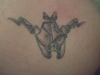 Kristy's new tatoo she got in Gatlinburg. Wedding Bells and a ribbon that says Scott on one side and Kristy on the other, with 12-09-03 in the middle