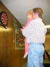 Emily showing Uncle Adam how to play darts